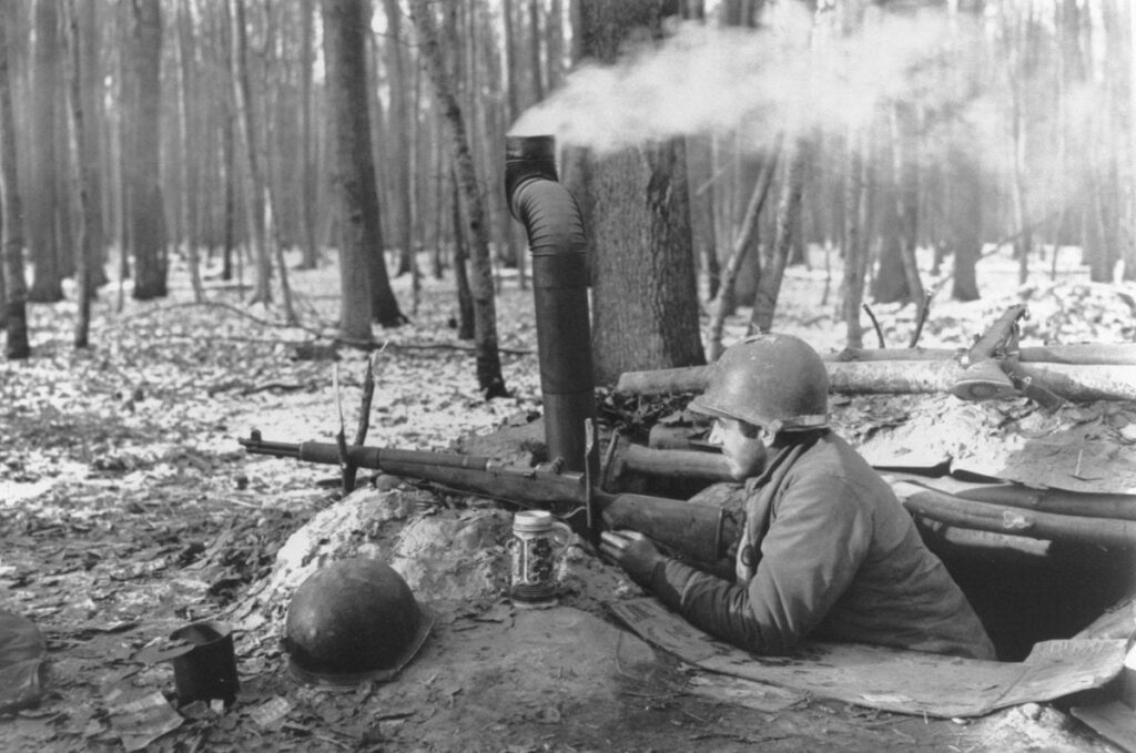 US soldier on guard in “luxurious” foxhole, Battle of the Bulge WW2